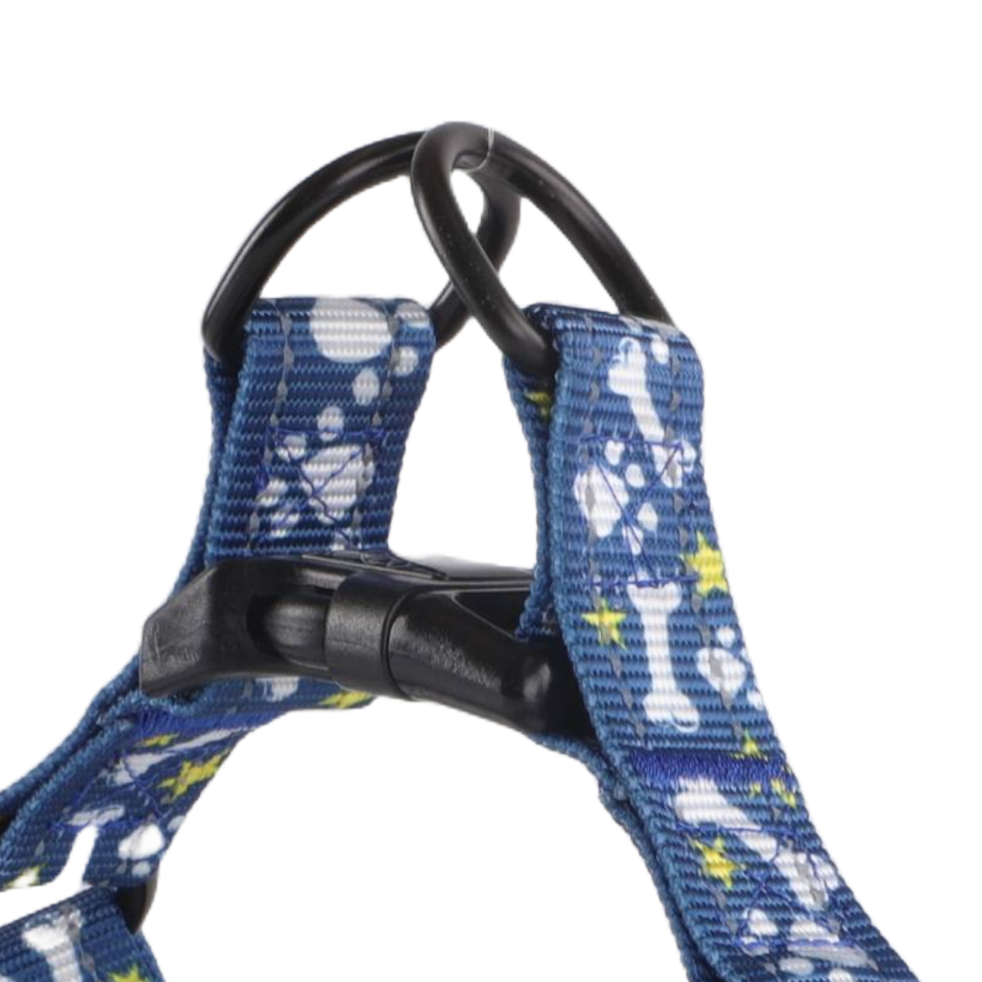 Close-up of a blue dog harness with paw print and bone design.