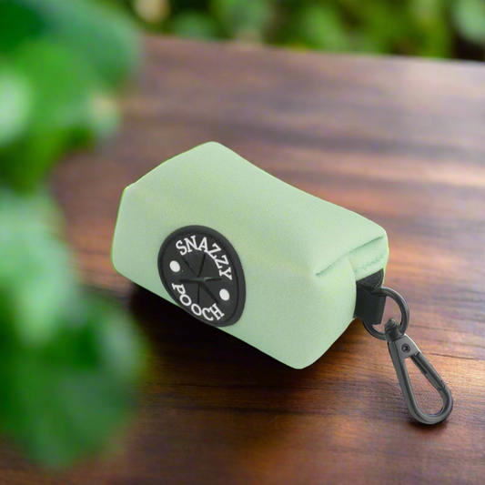 A light green Snazzy Pooch poop bag dispenser.