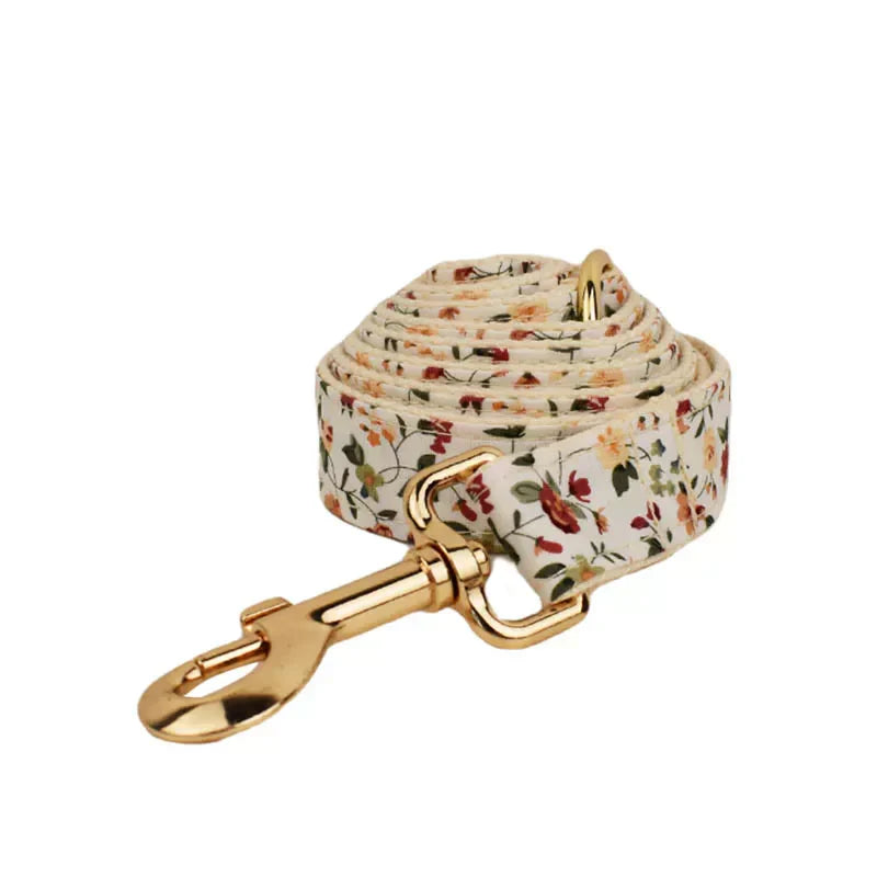 Floral patterned dog harness with engravable option, featuring a springtime design and gold buckle.