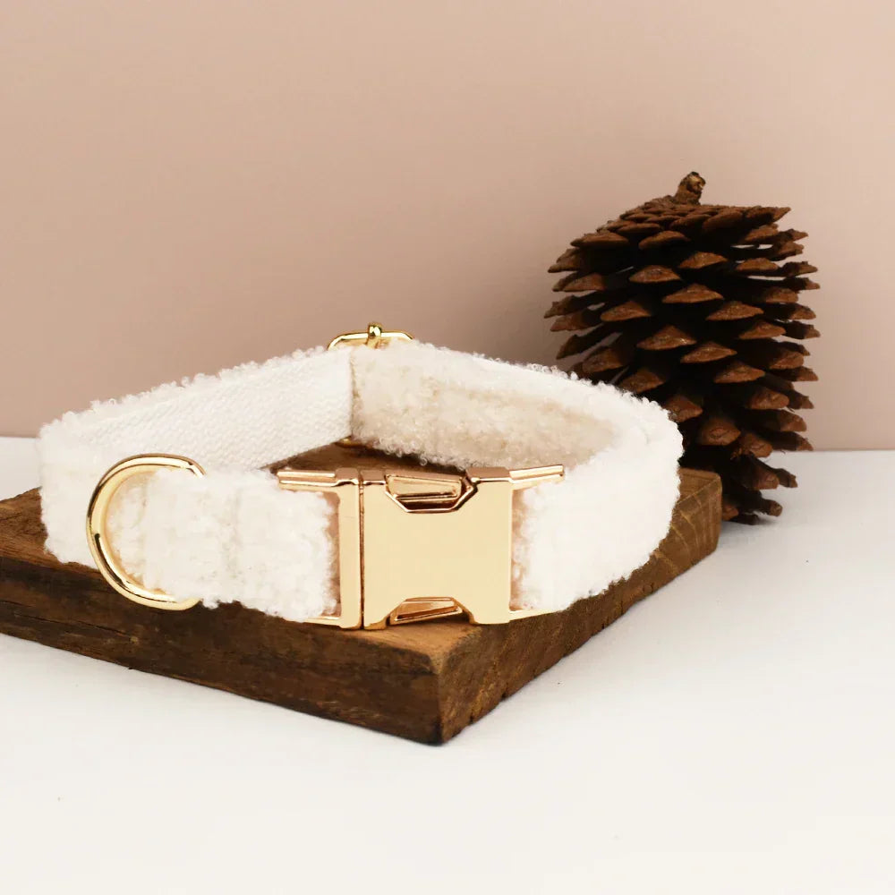 Teddy fleece personalised dog collar with gold buckle on wooden stand.