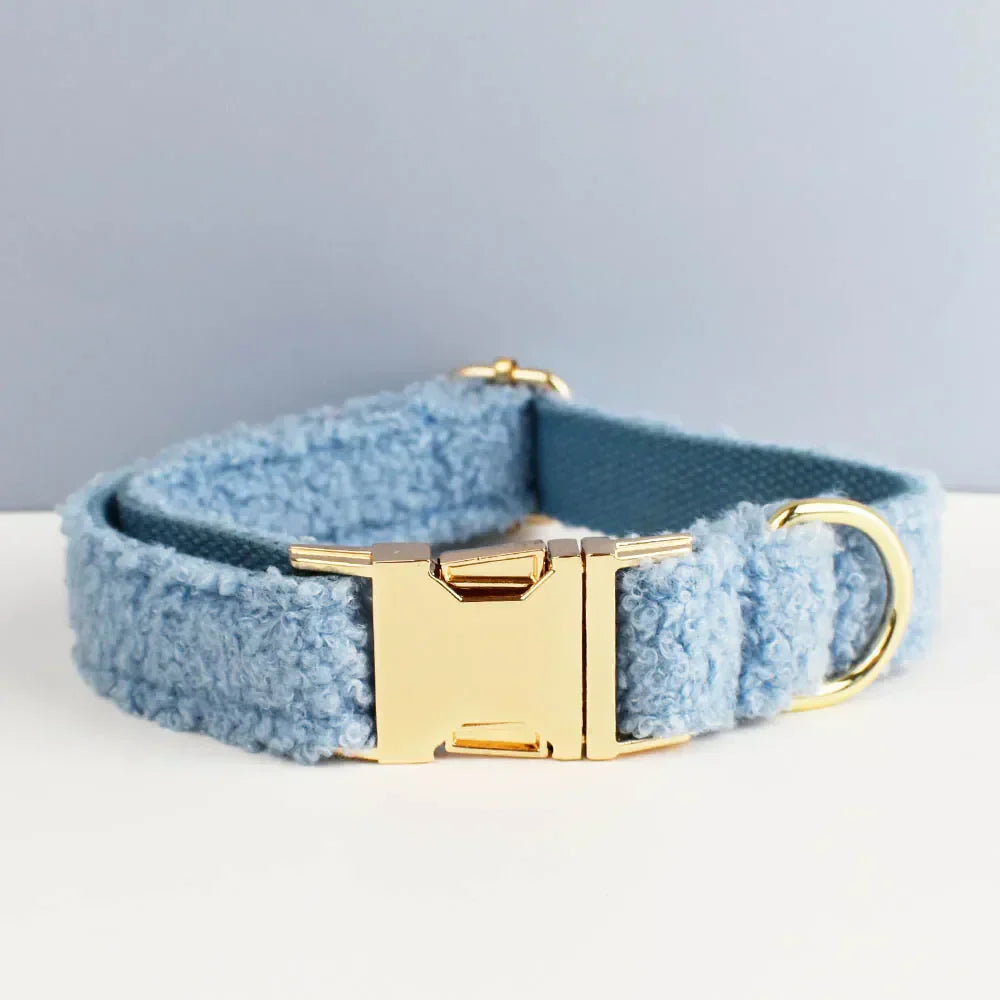 Teddy fleece personalised dog collar with gold hardware and blue fabric.