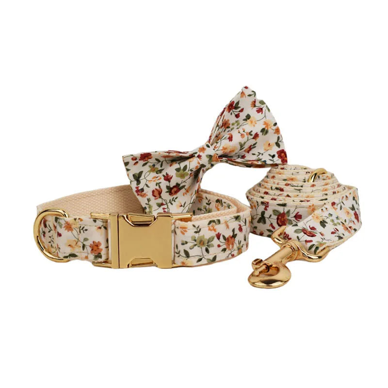 Floral-patterned luxury dog harness set with bow tie and leash.