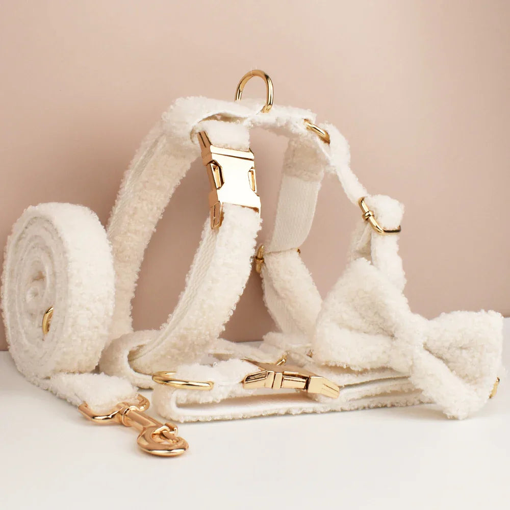 "The 'Wedding Tails' Teddy Fabric Dog Harness Collection in white with gold-tone hardware, featuring a bowtie and leash for weddings."