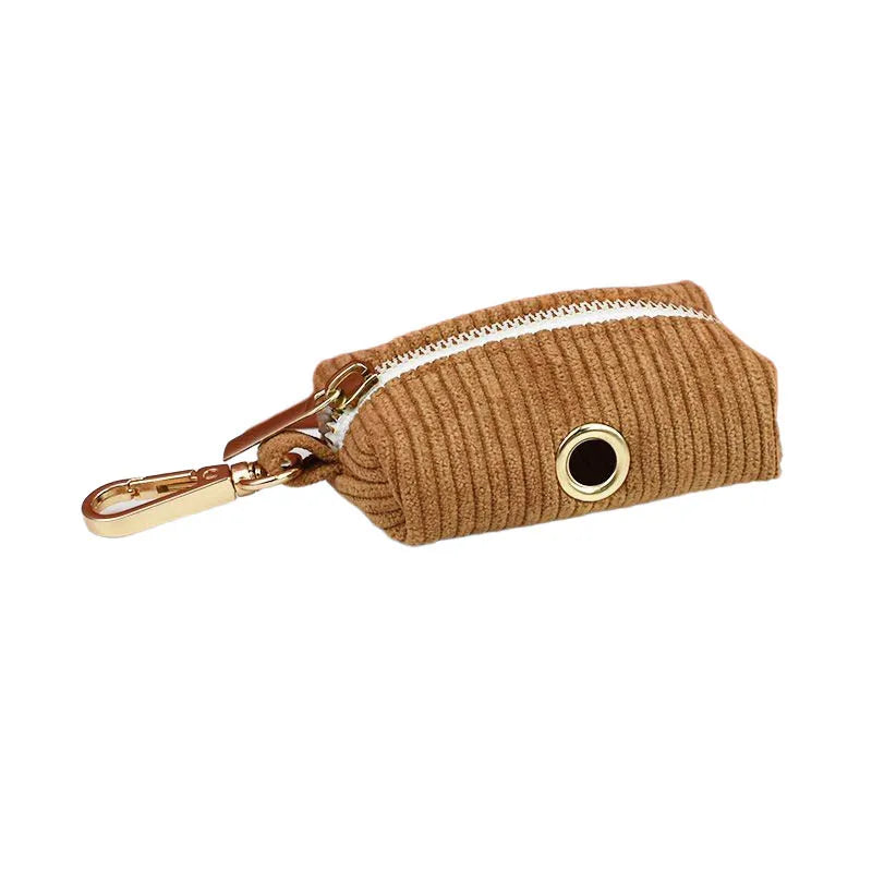 Caramel corduroy dog accessory with zip closure and metal clasp.