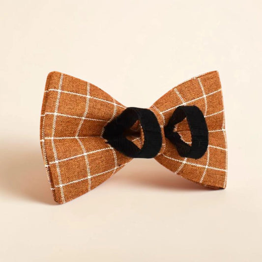 Brown check detachable dog bow tie on a beige background