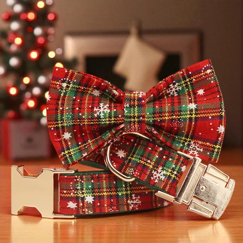 Red plaid dog collar with gold buckle on a wooden surface, Christmas tree in the background