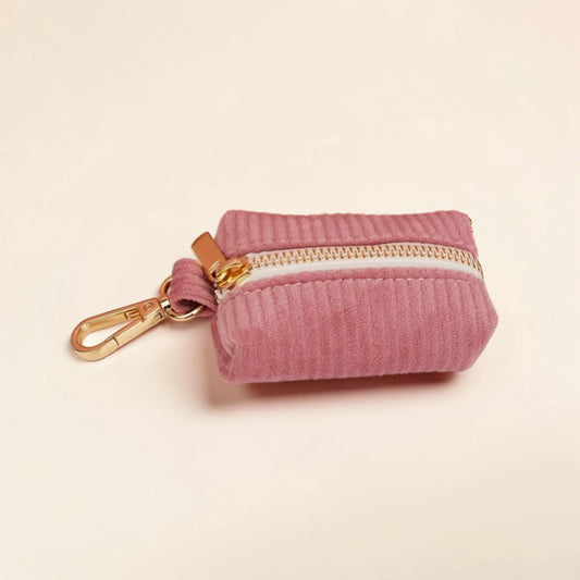 Powder pink dog poop bag holder with a gold zip and clip