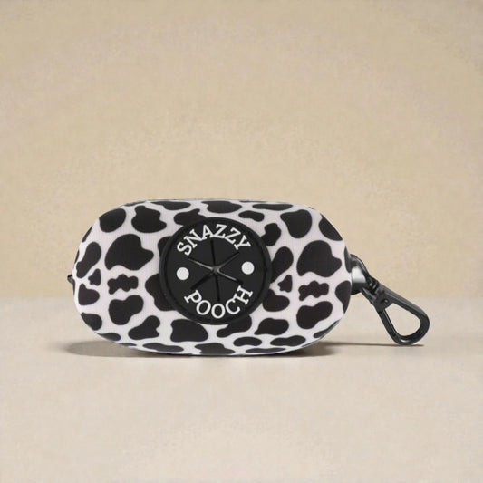 Black and white patterned dog waste bag dispenser with 'Snazzy Poach' branding on a beige background