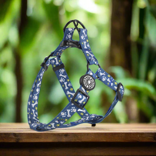 Blue dog harness with paw print and bone pattern.