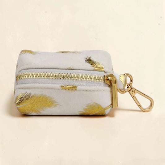 Golden feather dog poop bag holder with a gold zip and clip