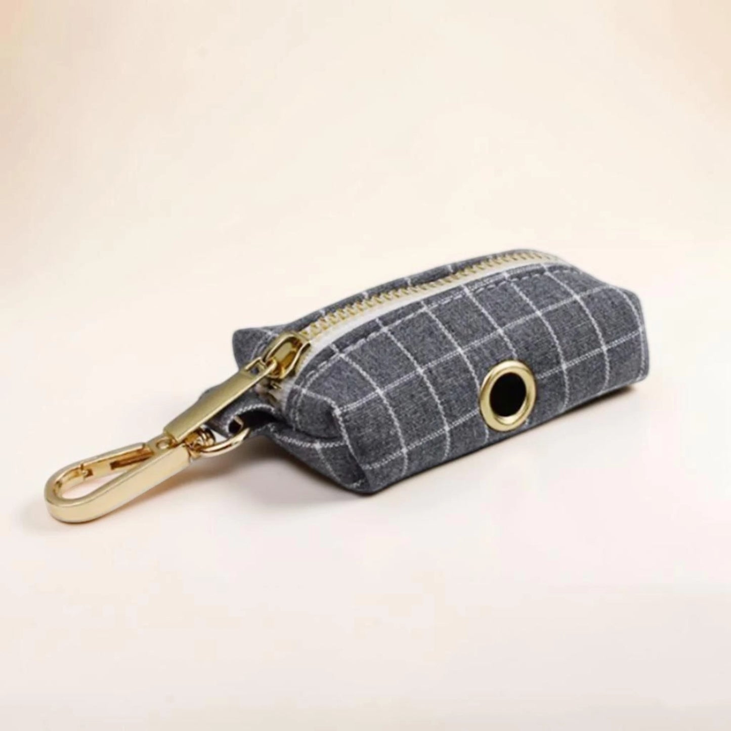 Grey check dog poop bag holder with gold zip and clip