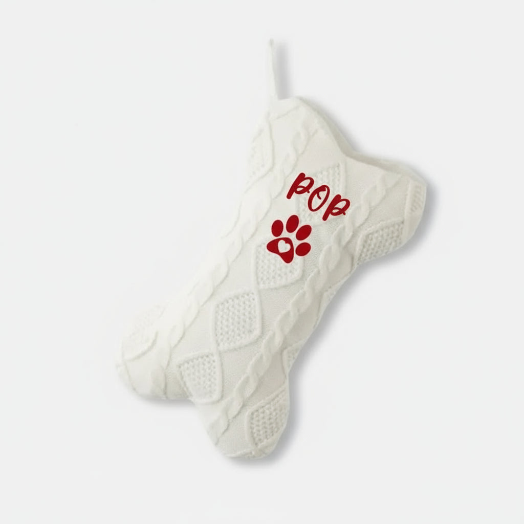 White xmas stocking with red text and paw print on a white background
