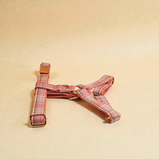Pink plaid dog harness on a beige background