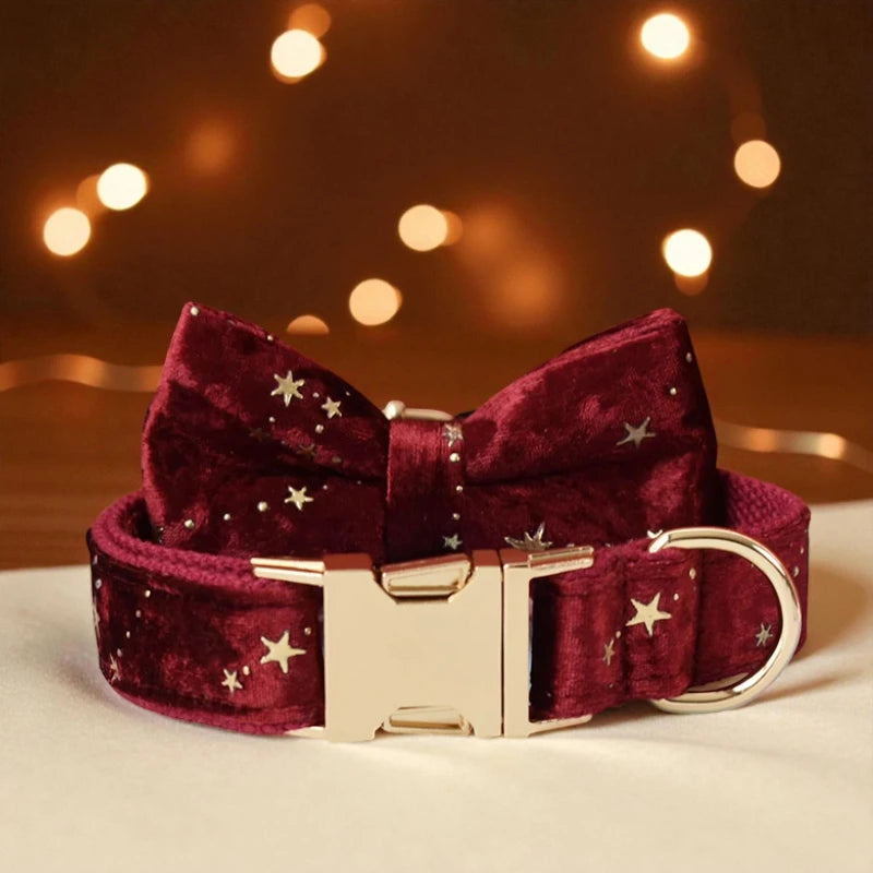 Red velvet dog collar with gold buckle and star patterns on a blurred warm background