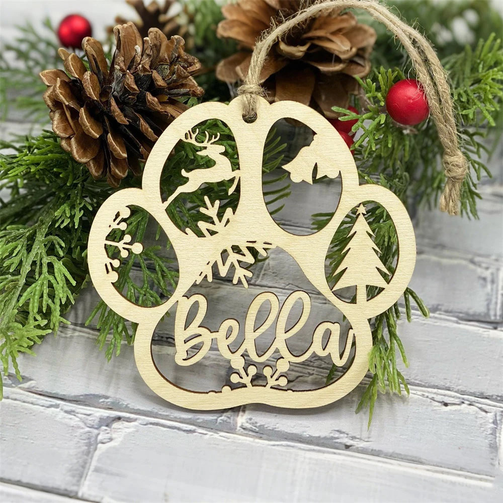 Wooden ornament with 'bella' engraved, surrounded by pine cones and greenery on a rustic wooden background.