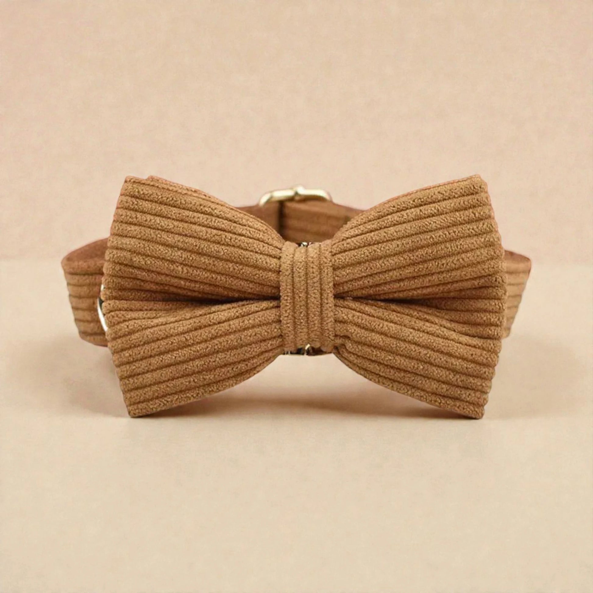 Brown ribbed bow tie on a beige background
