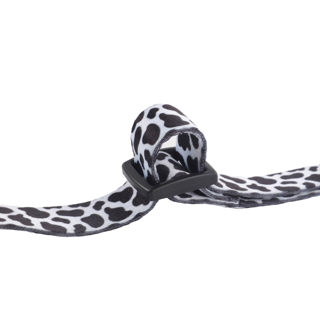Close-up of a dalmatian-print strap with a plastic buckle.