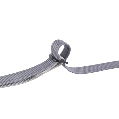 Close-up of a gray webbing strap with a black buckle.