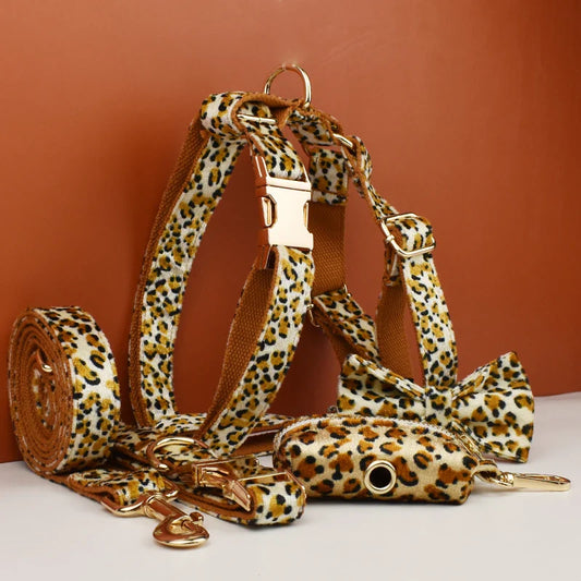 Customized designer logo leopard print dog collar and accessories set on brown base with quick release and padded features.