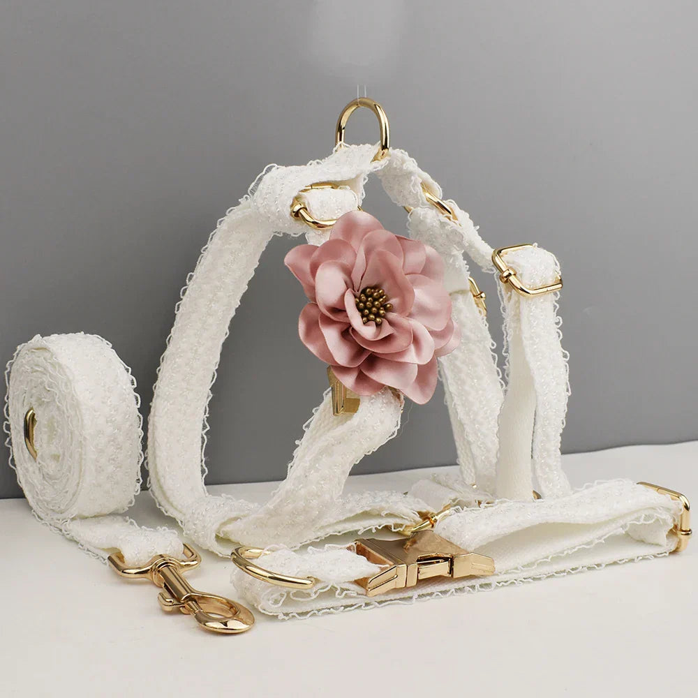 White lace dog harness set with gold-tone hardware and pink flower detail, ideal for dog wedding attire.