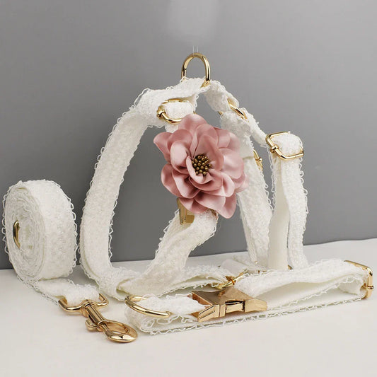 White lace dog harness set with gold-tone hardware and pink flower detail, ideal for dog wedding attire.
