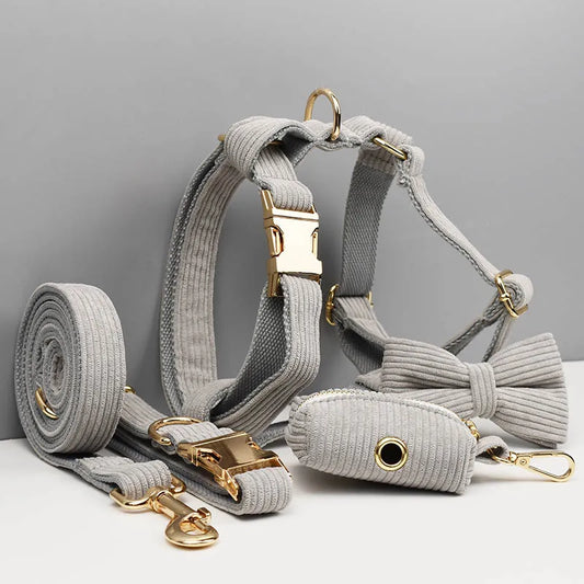 Luxury grey corduroy pet accessory set including harness, collar, lead, and bowtie with gold hardware.