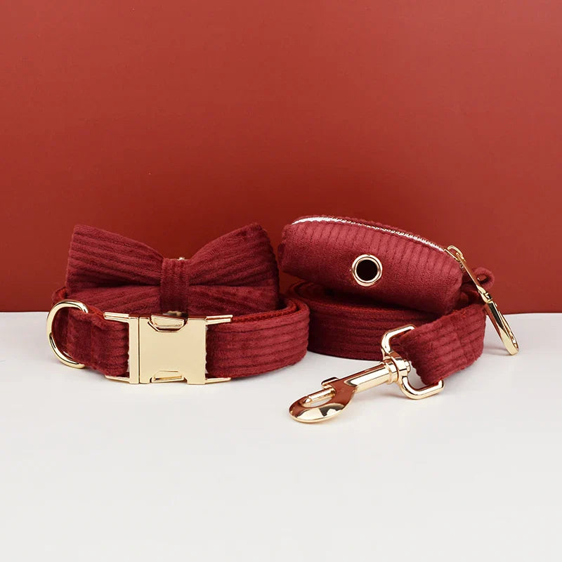 Handmade corduroy fabric luxury pet accessories in red, including harness, collar, lead, and bowtie.