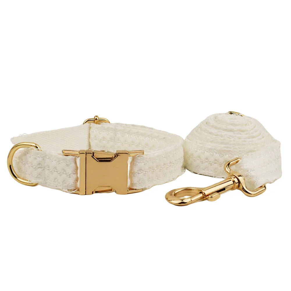 White lace dog harness with gold-tone hardware for weddings, featuring an elegant design for stylish pet wedding attire.