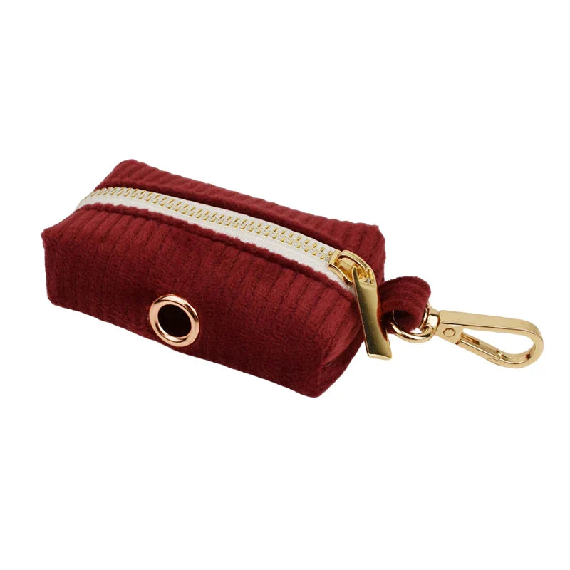 Red handmade corduroy fabric pet accessory with gold hardware clasp.