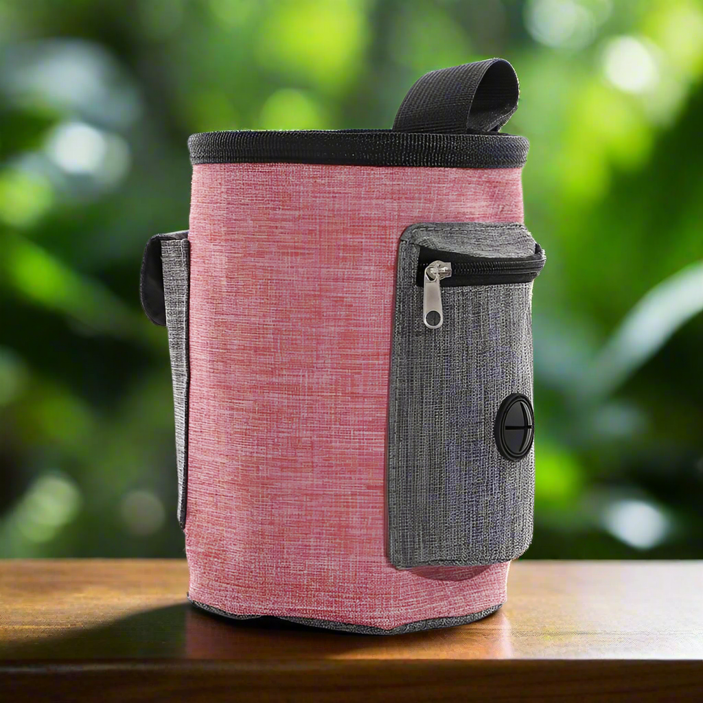 Versatile Treat Pouch for dog training with multiple compartments, pink and grey linen, displayed outdoors.