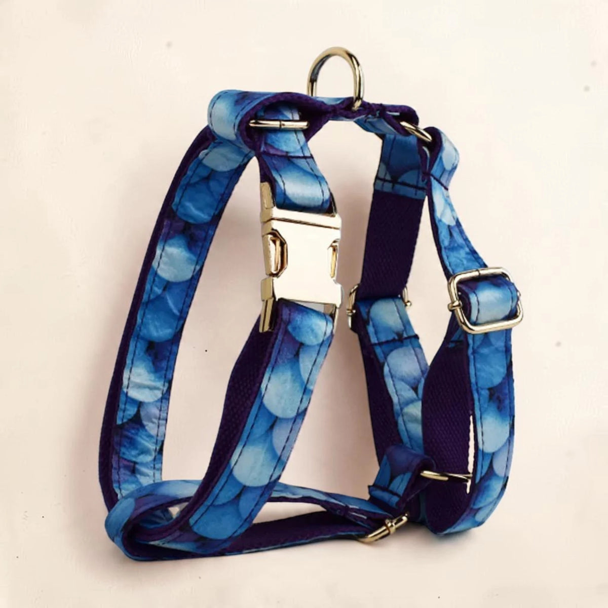 Blue patterned dog harness with gold-tone metal hardware. Buckle can be personalised.