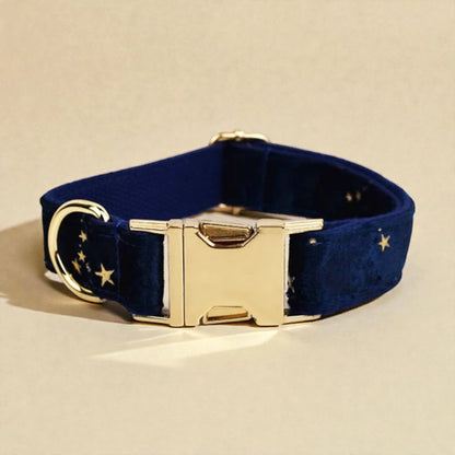Navy blue velvet dog collar with gold hardware on a beige background