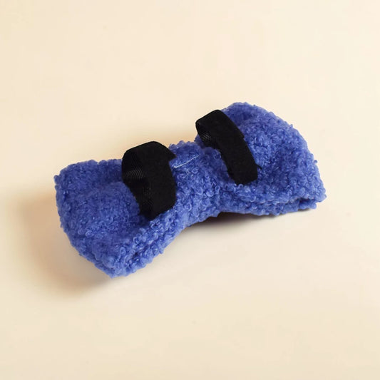Blue teddy fleece detachable dog bow on a beige background