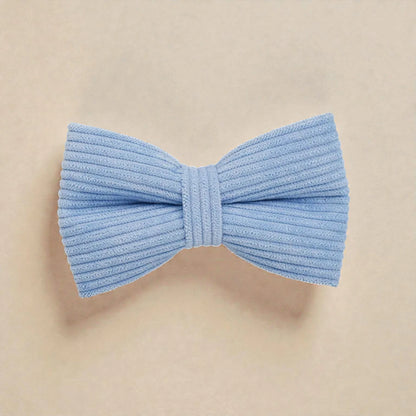Light blue bow tie on a beige background