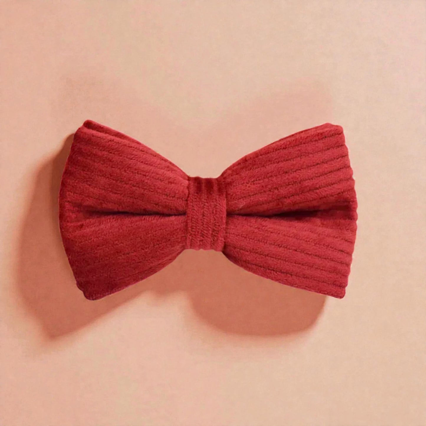 Red bow on a beige background