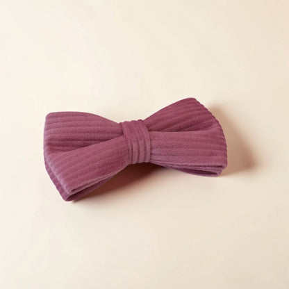Powder pink dog bow on a beige background
