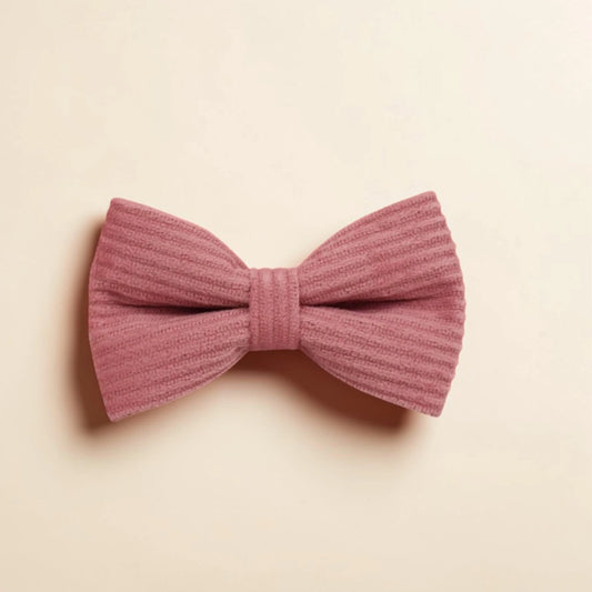 Pink corduroy dog bow on a beige background