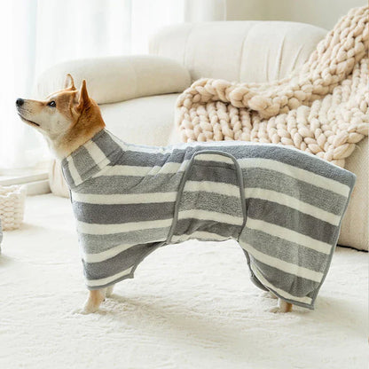 Dog wearing a grey and white striped fleece drying robe, showcasing its cozy and efficient design.