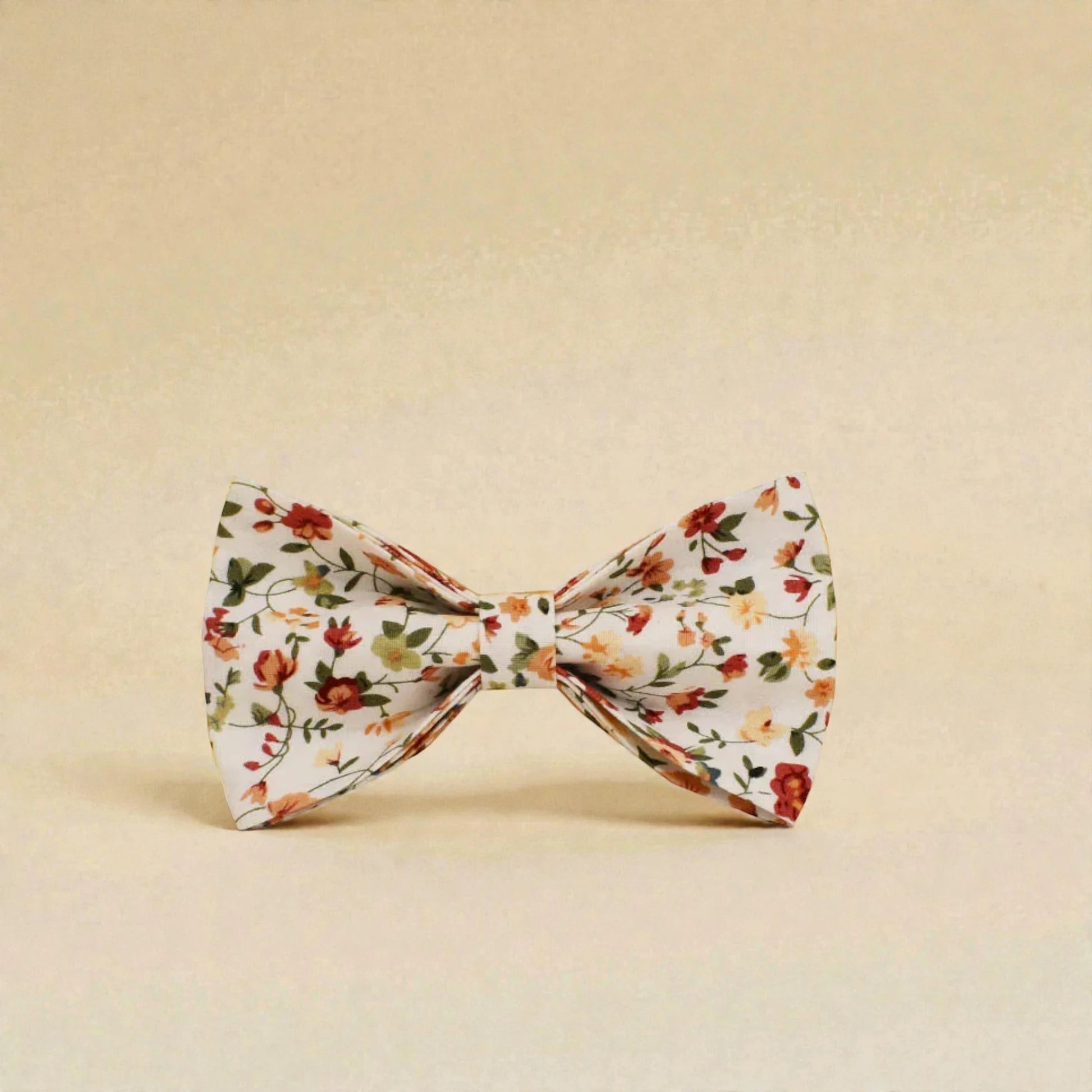 Floral patterned dog bow tie on a beige background