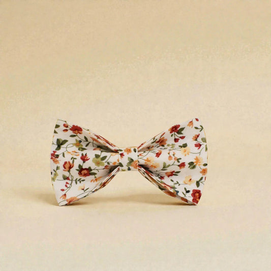 Floral patterned dog bow tie on a beige background