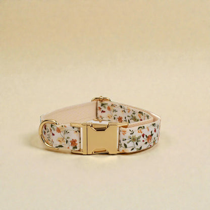 Floral-patterned dog collar with a gold buckle on a beige background