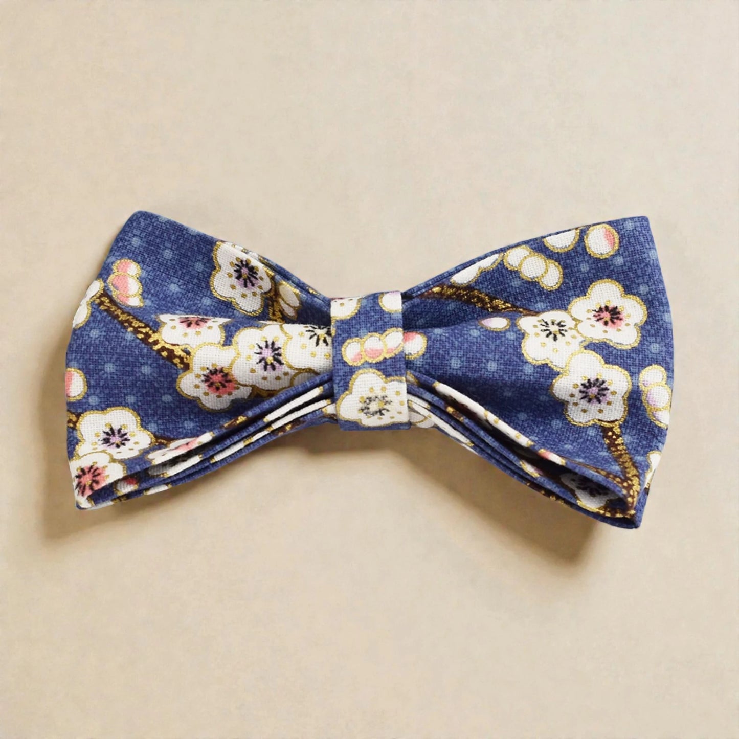 Floral patterned  blue bow tie on a beige background