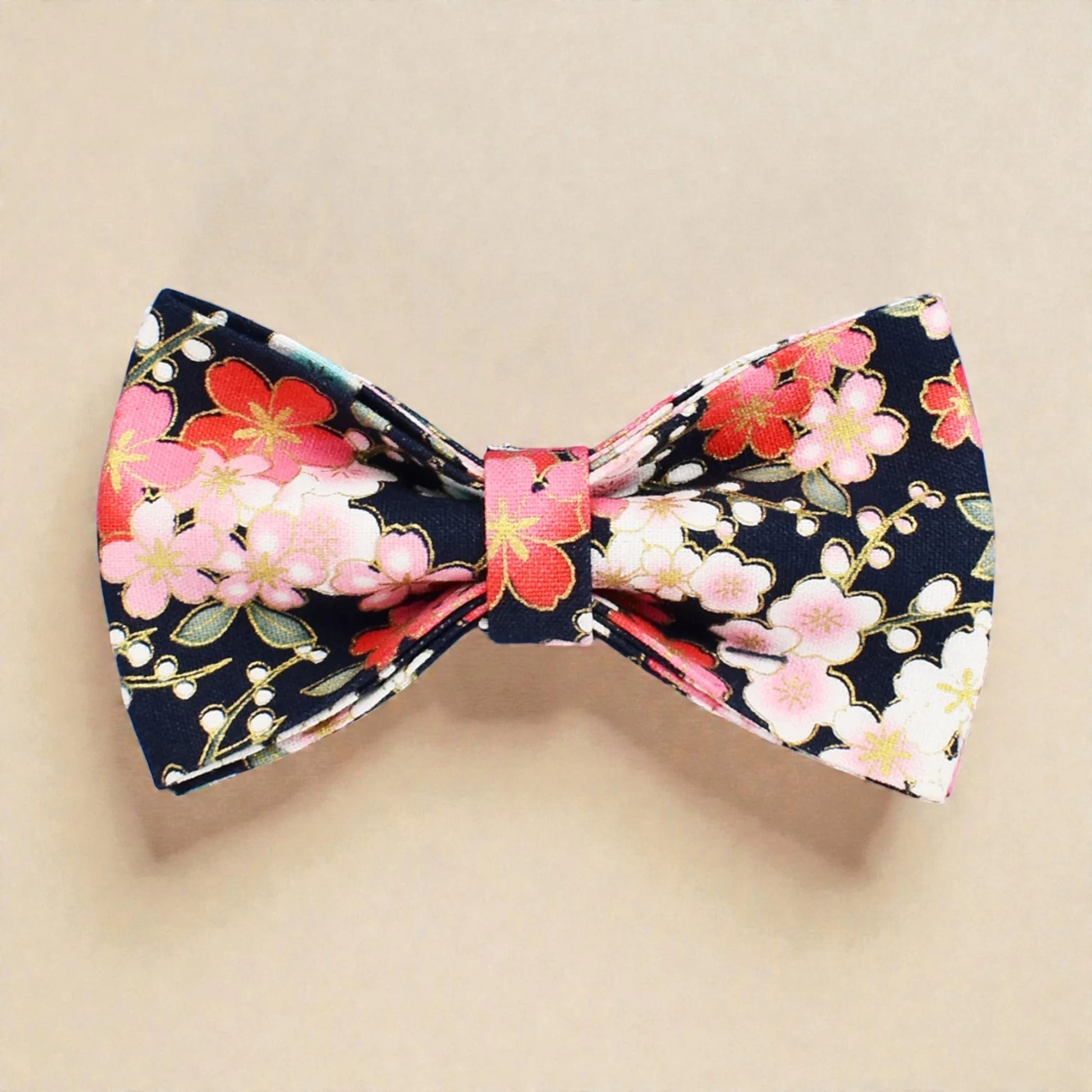 Floral bow tie with pink and red flowers on a beige background