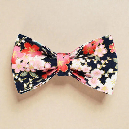 Floral bow tie with pink and red flowers on a beige background