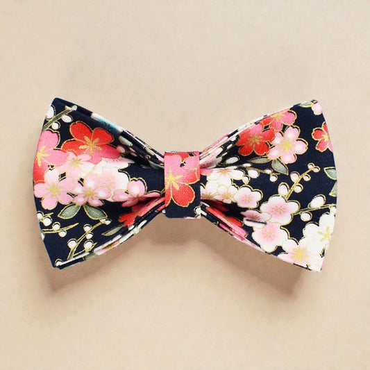 Floral bow tie with pink and red flowers on a beige background