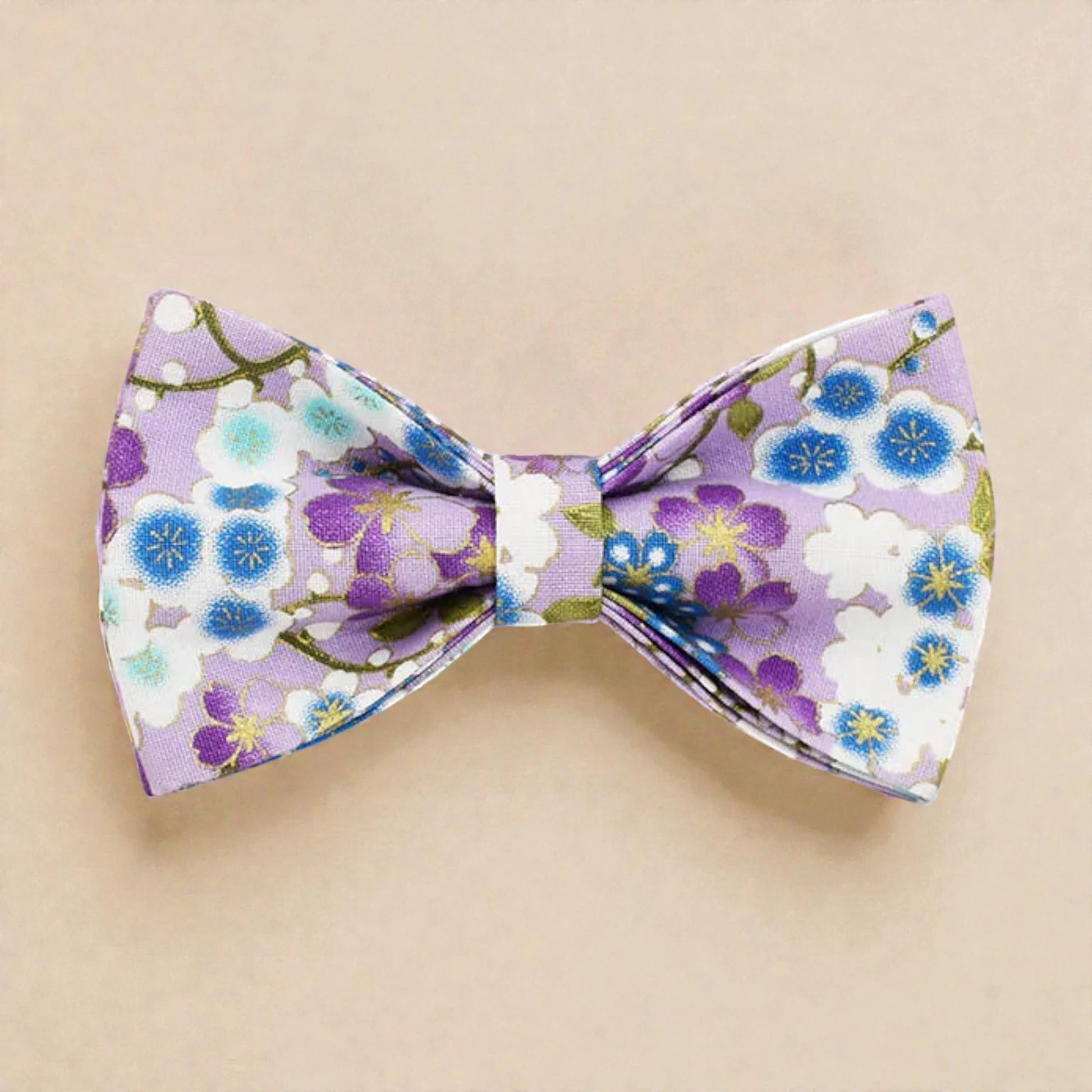 Floral patterned bow tie on a beige background
