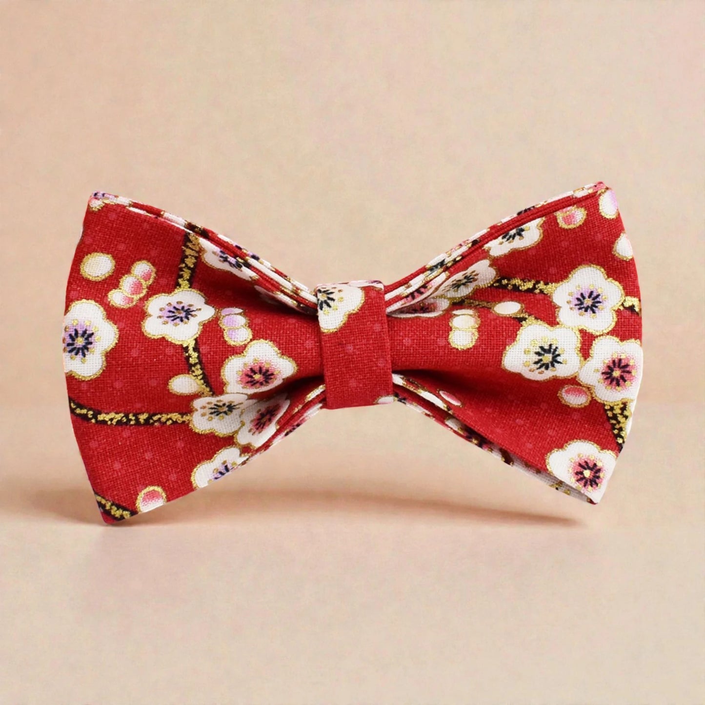 Red floral bow tie on a beige background