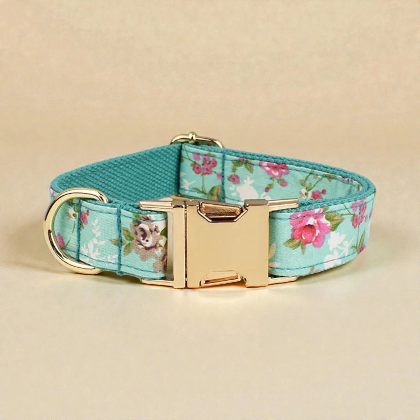 Floral-patterned dog collar with gold buckle on a beige background