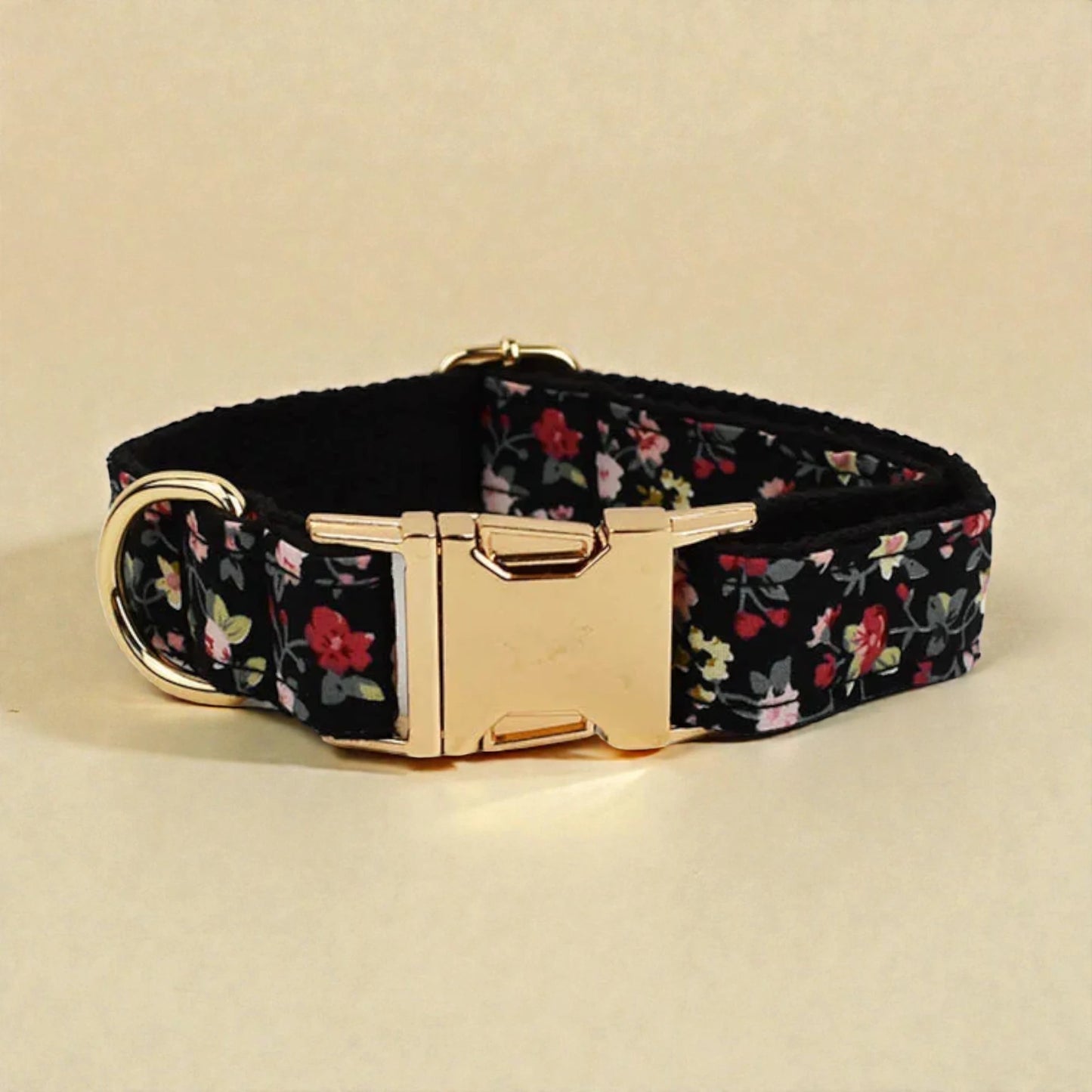 Floral-patterned dog collar with a gold buckle on a beige background