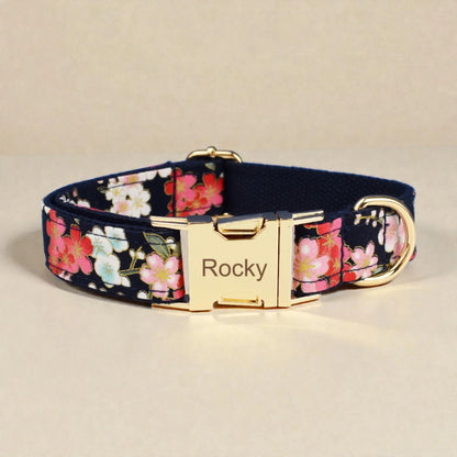 Floral-patterned dog collar with a gold buckle on a beige background